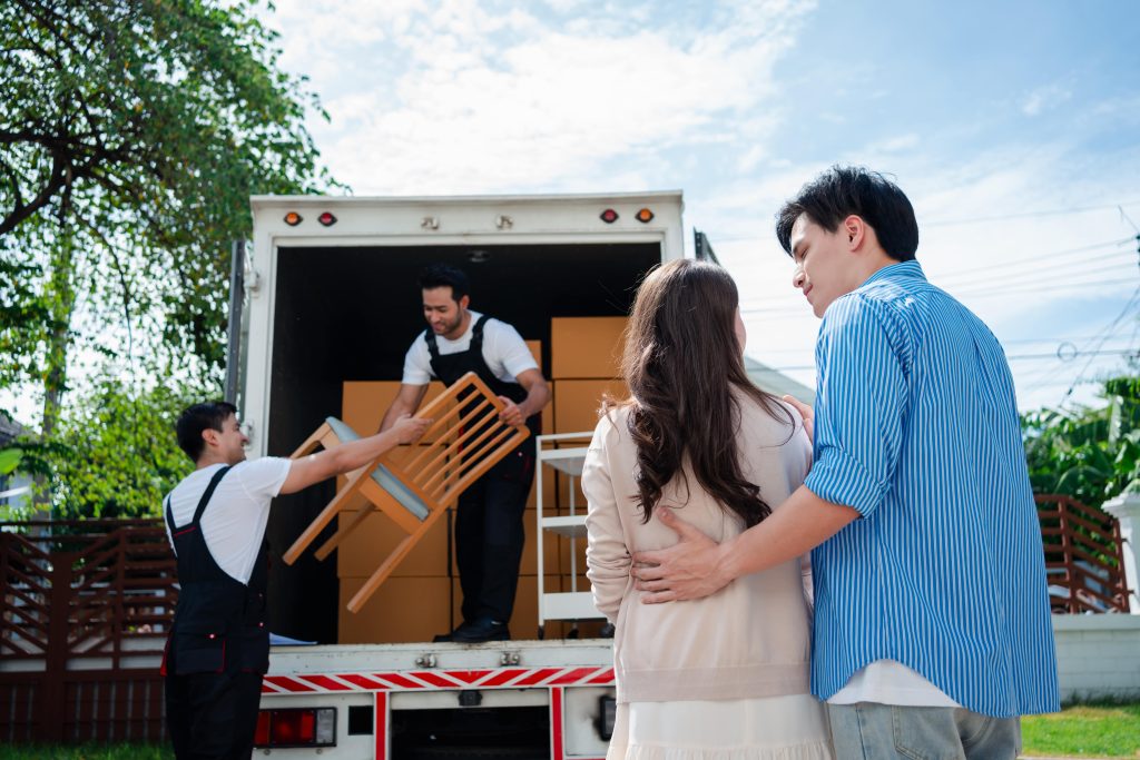 A happy couple watching gordons moving help move their furniture safely in maine